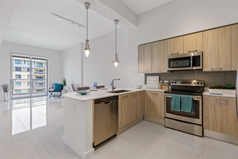 a kitchen with wooden cabinets and stainless steel appliances