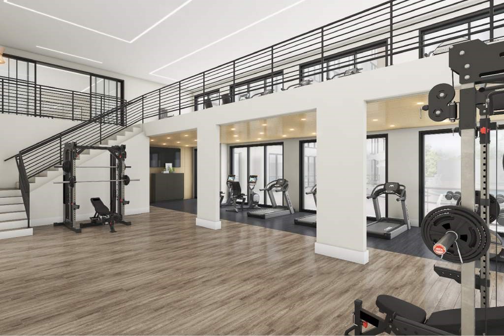 a workout room with weights and a spiral staircase
