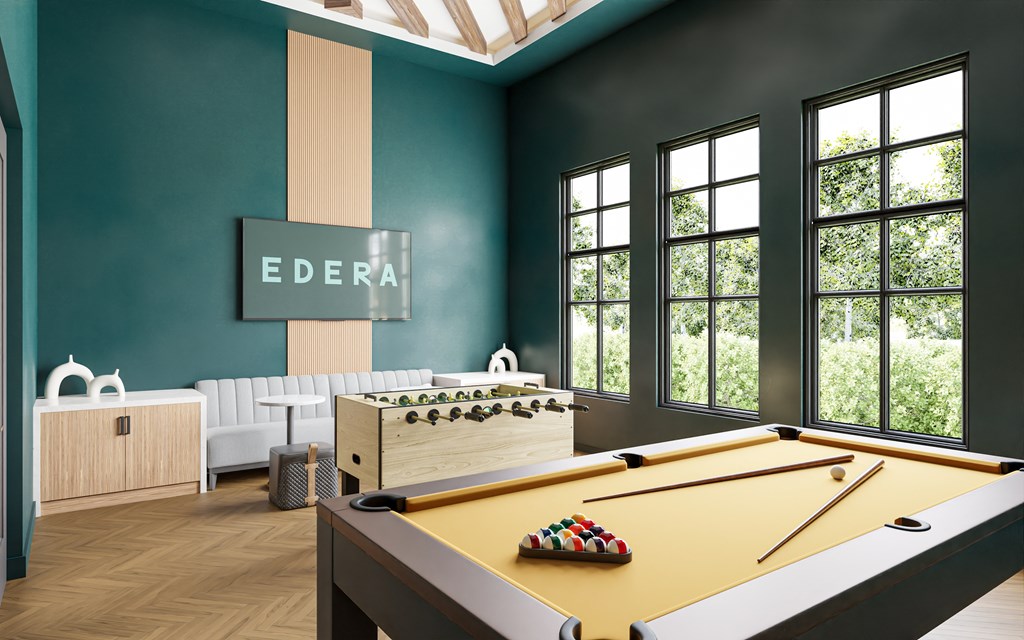 a game room with a pool table and a view of the trees