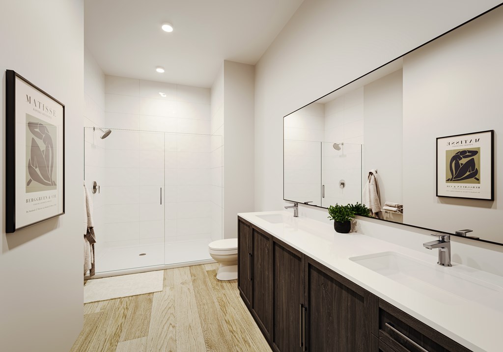 a bathroom with a large mirror and a sink and a shower