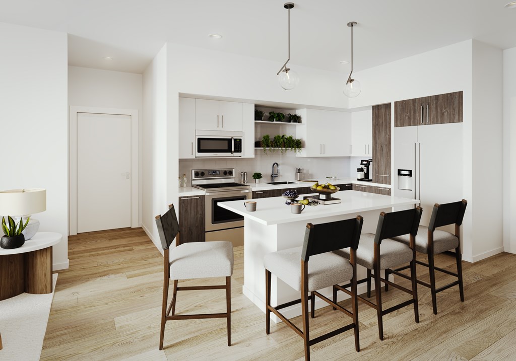 a kitchen with a white island and black chairs