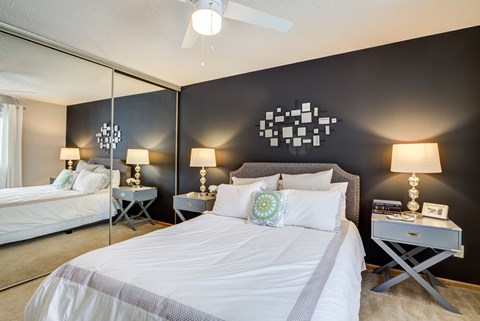 a bedroom with two beds and a ceiling fan