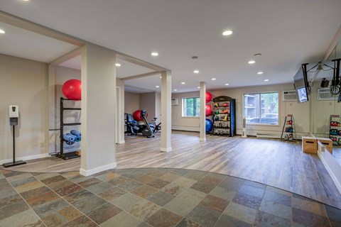 A spacious room with a tiled floor and a balloon on the left.