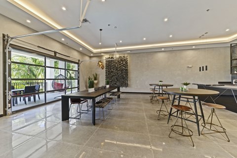 A spacious dining area with a long table and chairs.