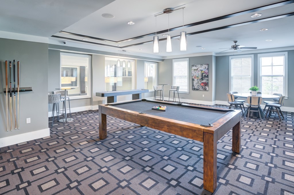 a recreation room with a pool table and ping pong table