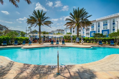 a swimming pool with a fountain in front of a building