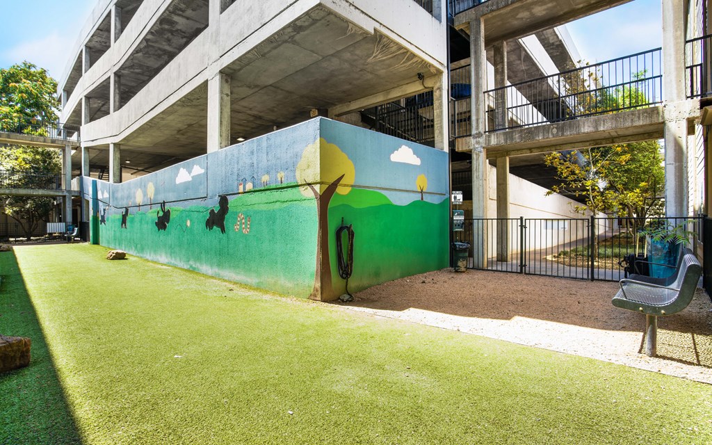 a mural on the side of the pet park