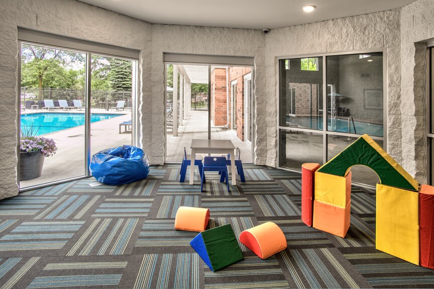 a lobby with colorful chairs and a swimming pool