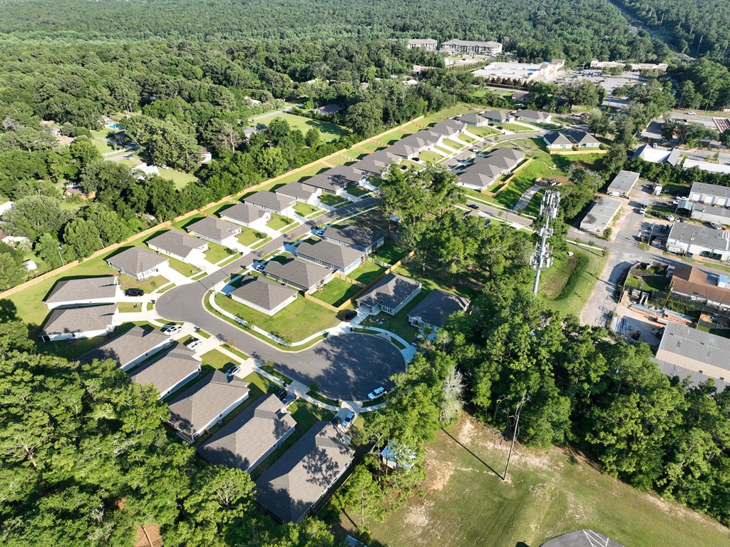 an aerial view of a parking lot in front of a school