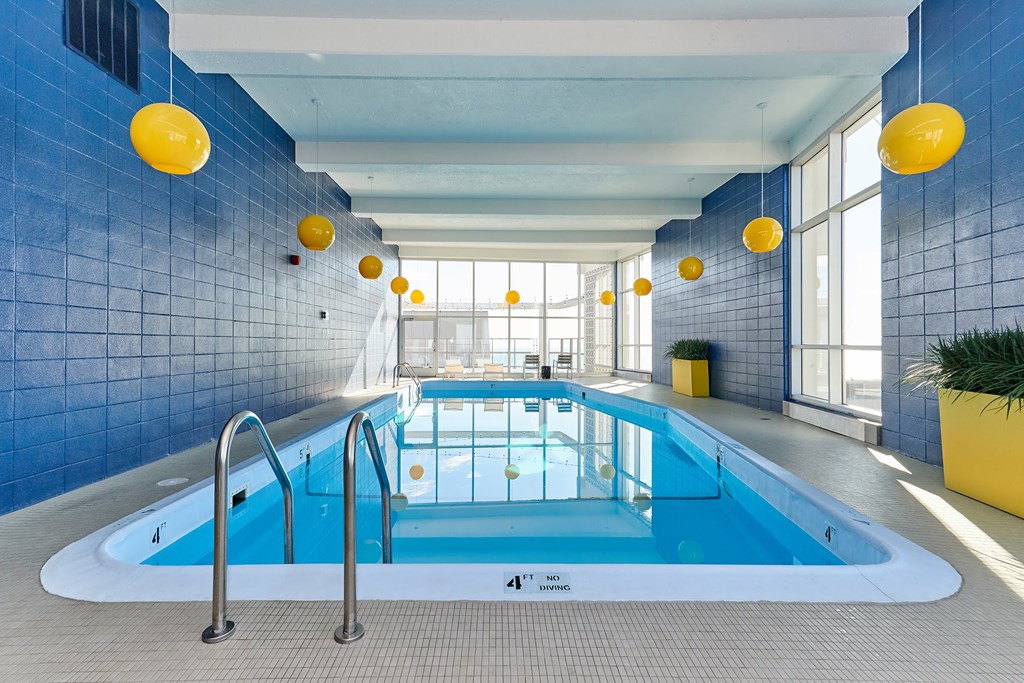 Chicago Lakeview IL Apartments for Rent - Wave Lakeview - Rooftop Indoor Heated Pool With Chicago Skyline Views Through The Windows