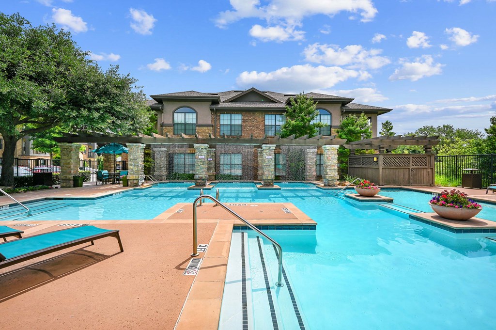 a swimming pool with a house in the background