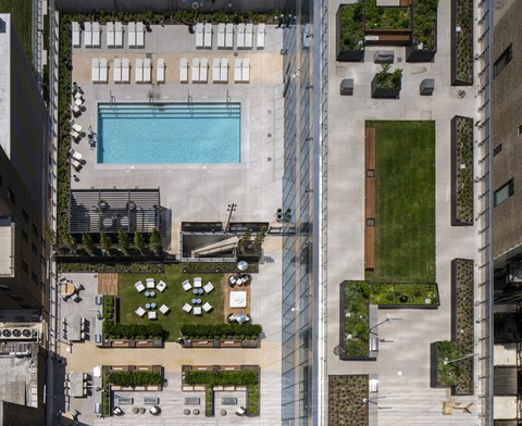 A large outdoor swimming pool surrounded by a glass fence.