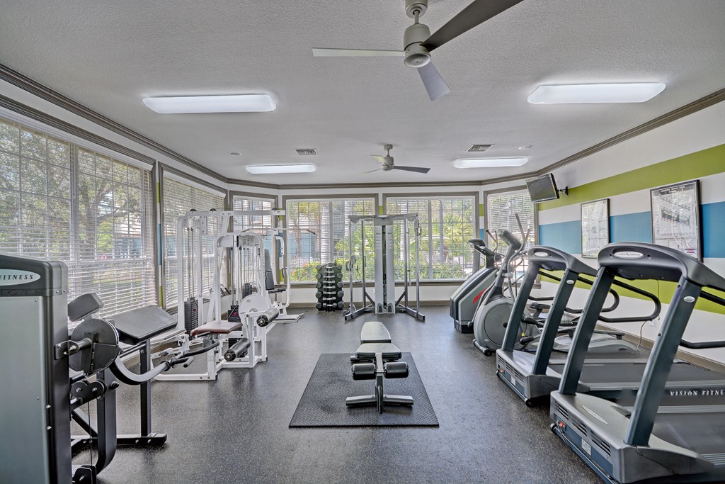 a gym with treadmills and other exercise equipment