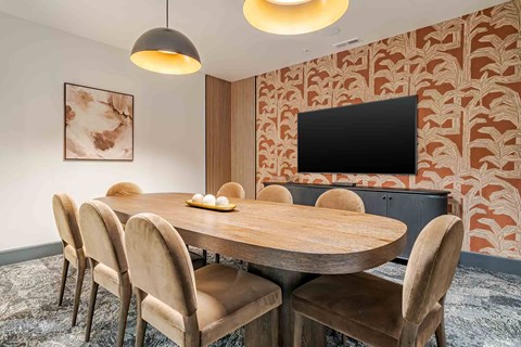 A modern dining room with a wooden table and chairs.