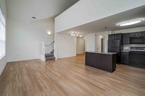 A kitchen with a countertop and cabinets is visible in the image.