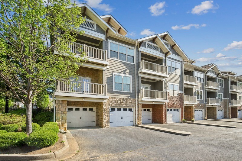 an empty parking lot in front of an apartment building