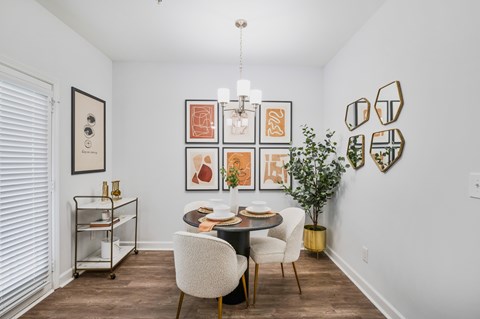 a dining room with a table and chairs and a chandelier