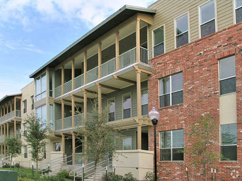 a brick building with balconies and a street light