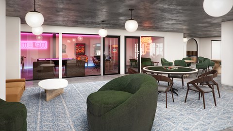 A room with a green sofa and a round table.