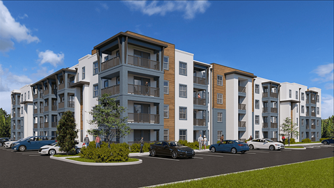 A modern apartment complex with multiple buildings and cars parked in front.