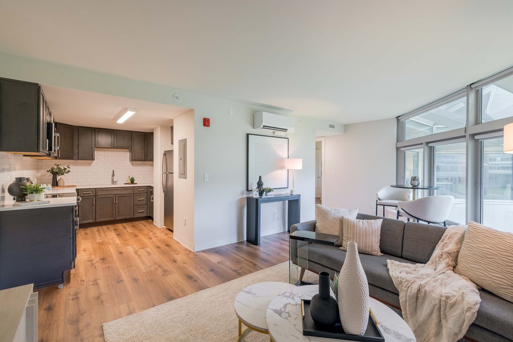 a living room and kitchen with a couch and a table