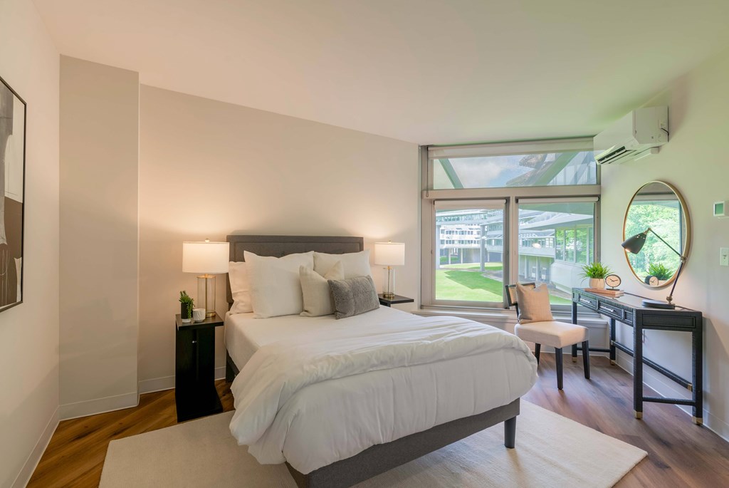 a bedroom with a large bed and a large window