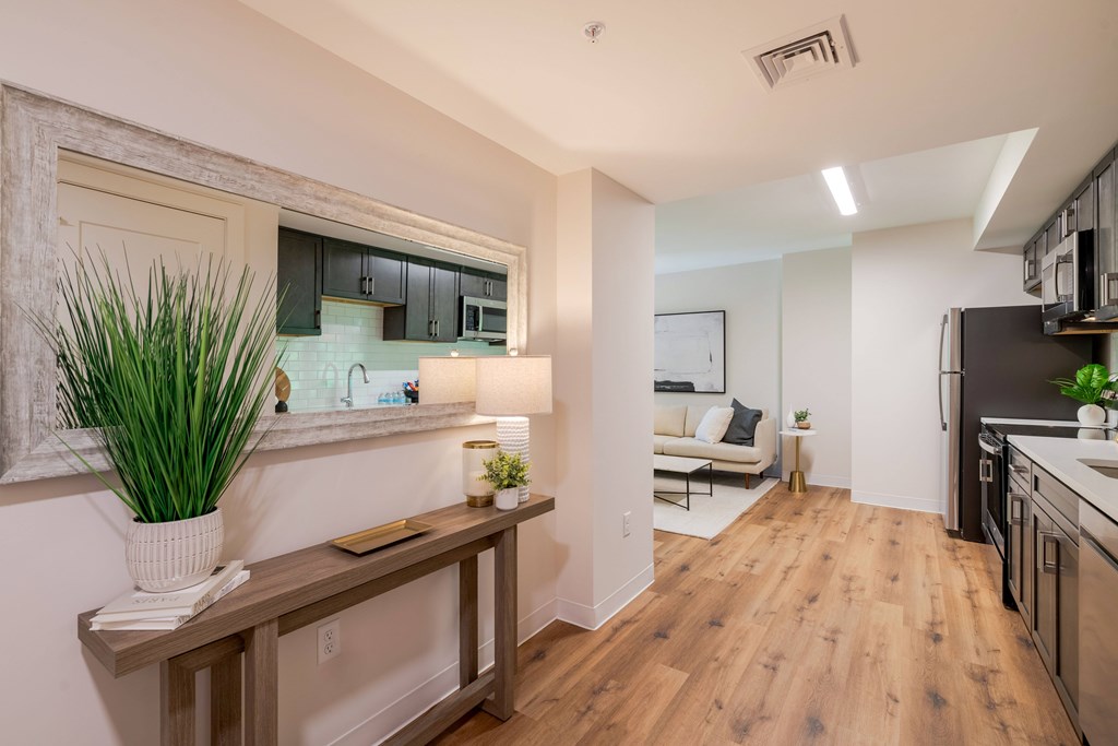 a living room and dining room with a wood floor and white walls