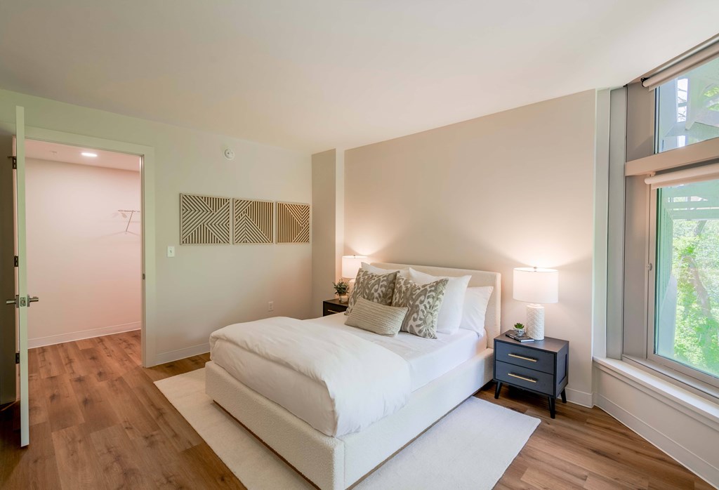 a bedroom with a bed and a large window