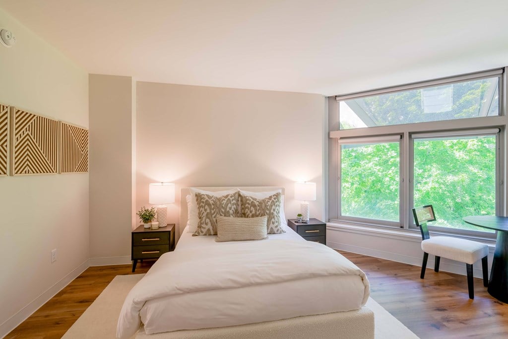 a bedroom with a bed and a large window