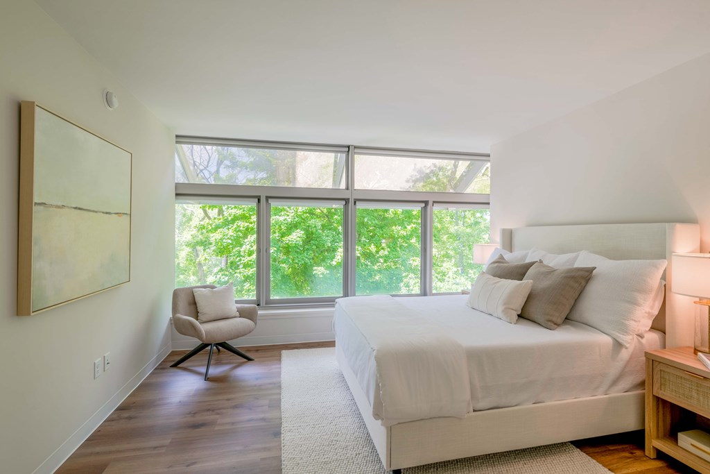 a bedroom with a bed and a large window