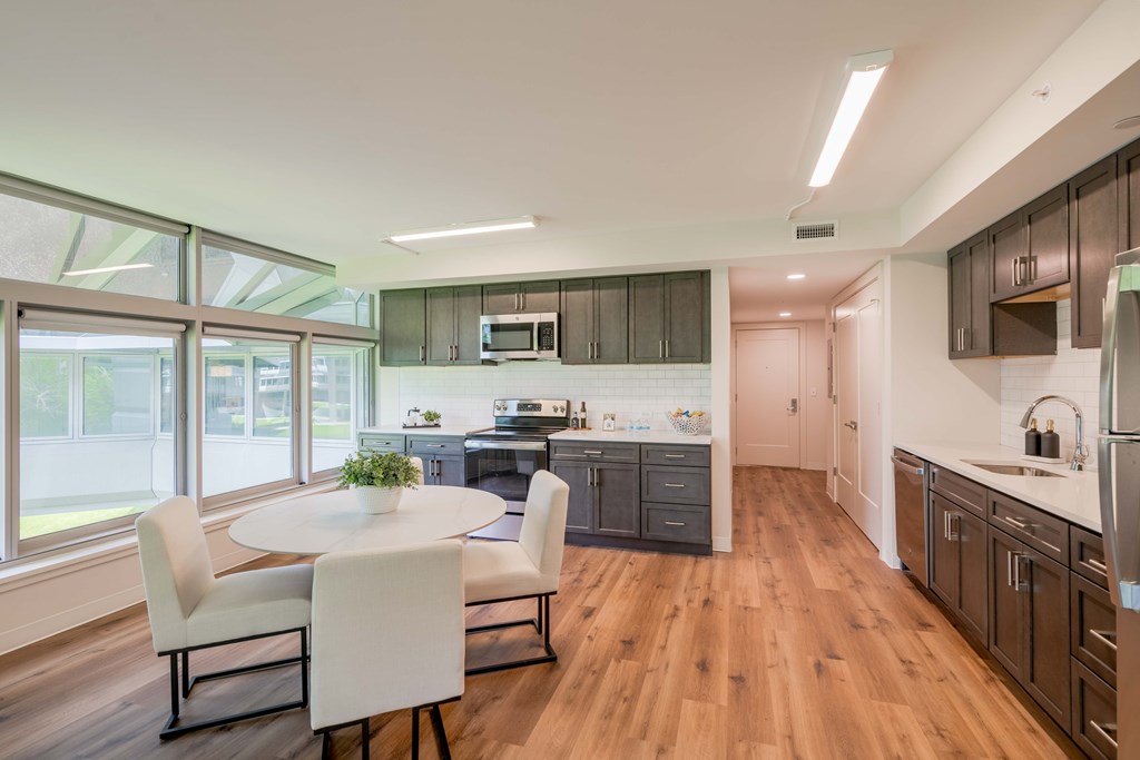 a kitchen and dining room with a white table and chairs