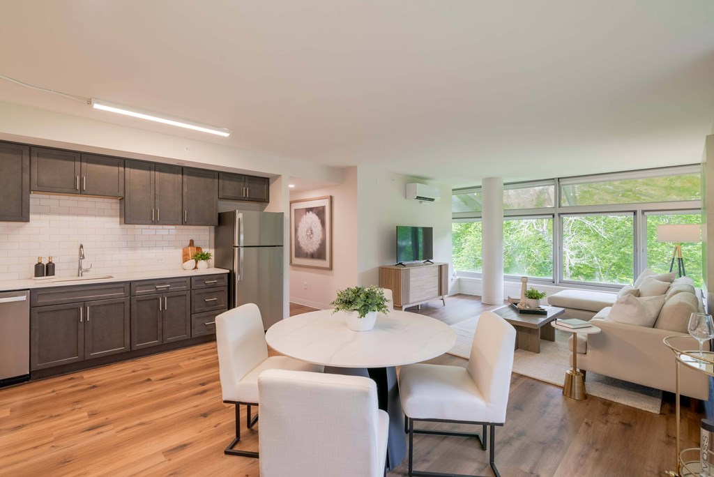 a kitchen and dining room with white chairs and a white table