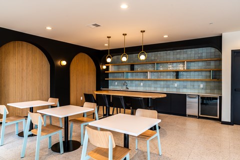 A modern dining area with tables and chairs.