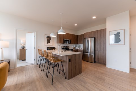 A modern kitchen with a dining table and chairs.