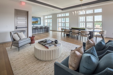 A living room with a grey couch and a white coffee table.