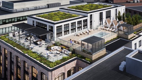 A modern building with a green roof and a patio area.