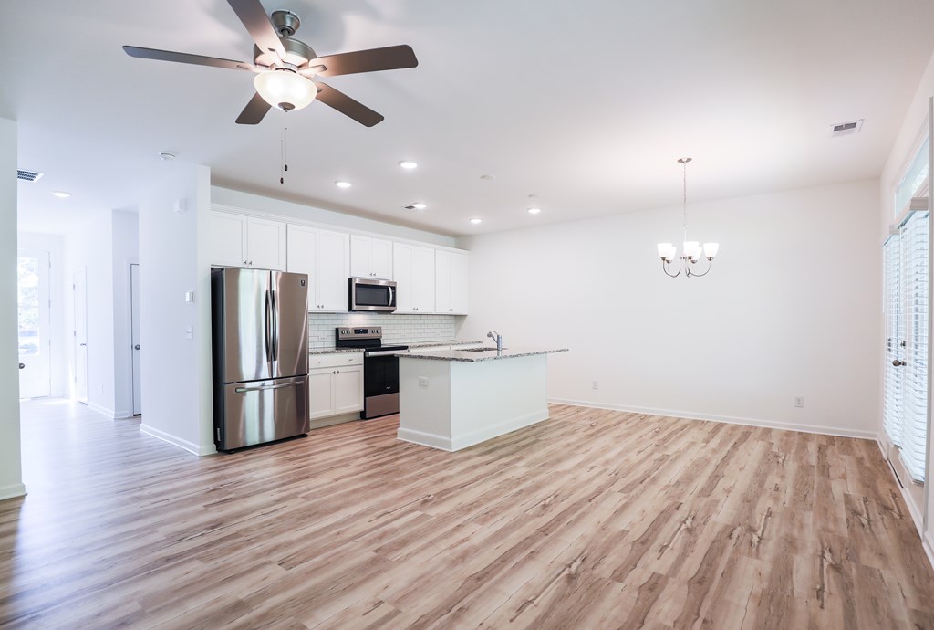 an empty dance floor with a ceiling fan