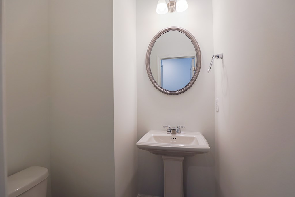 a small bathroom with a sink and a mirror
