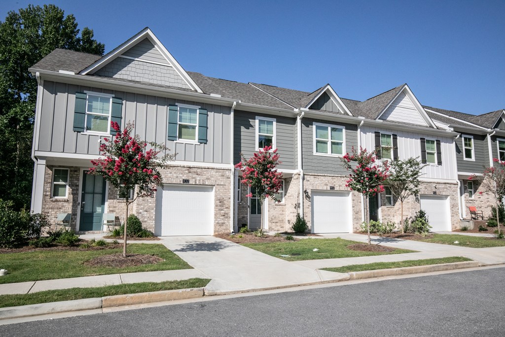 a house with two garage doors on a street