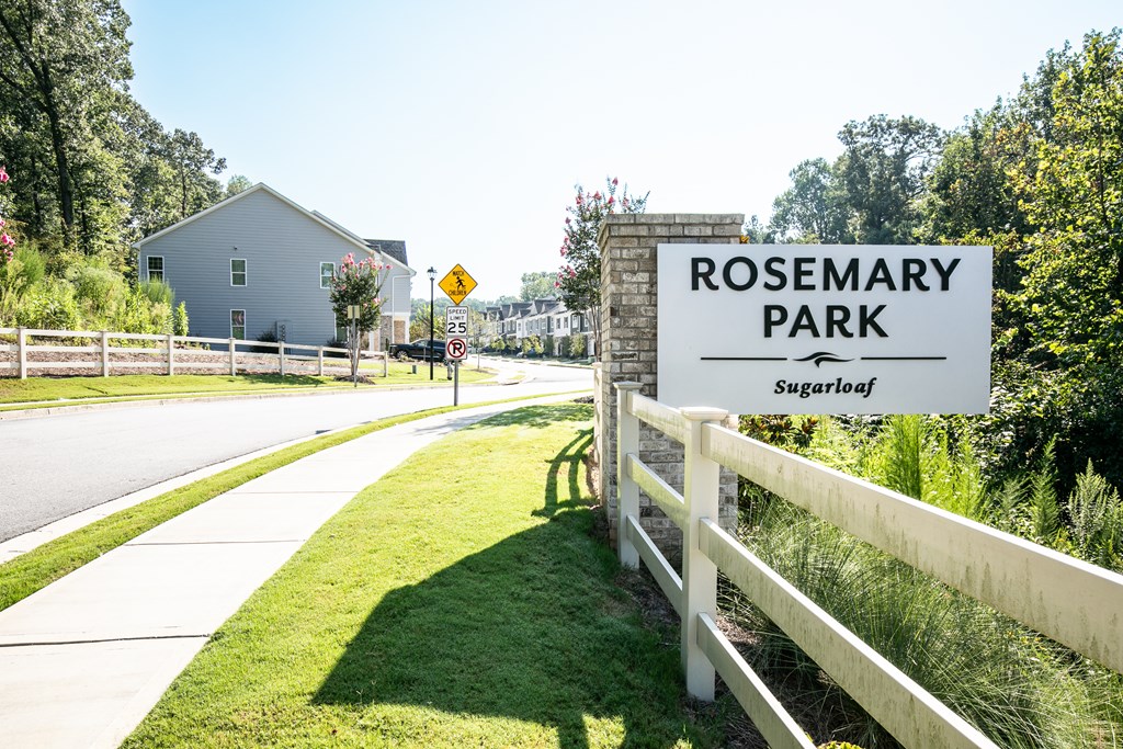 a sign for rosemary park on the side of a road