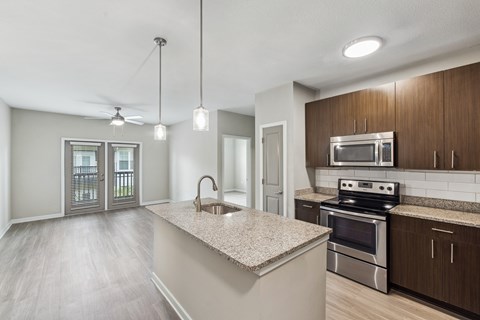 A kitchen with a stove top oven and microwave above the counter.