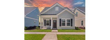 a blue house with a sidewalk in front of it