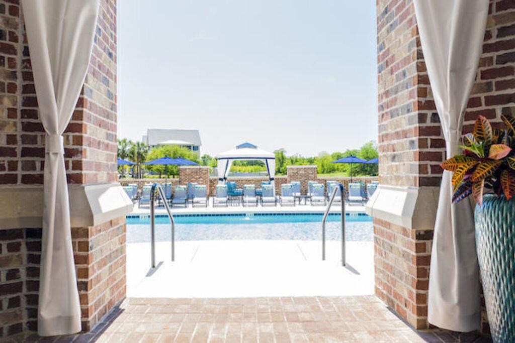 a swimming pool with chairs and umbrellas at a resort