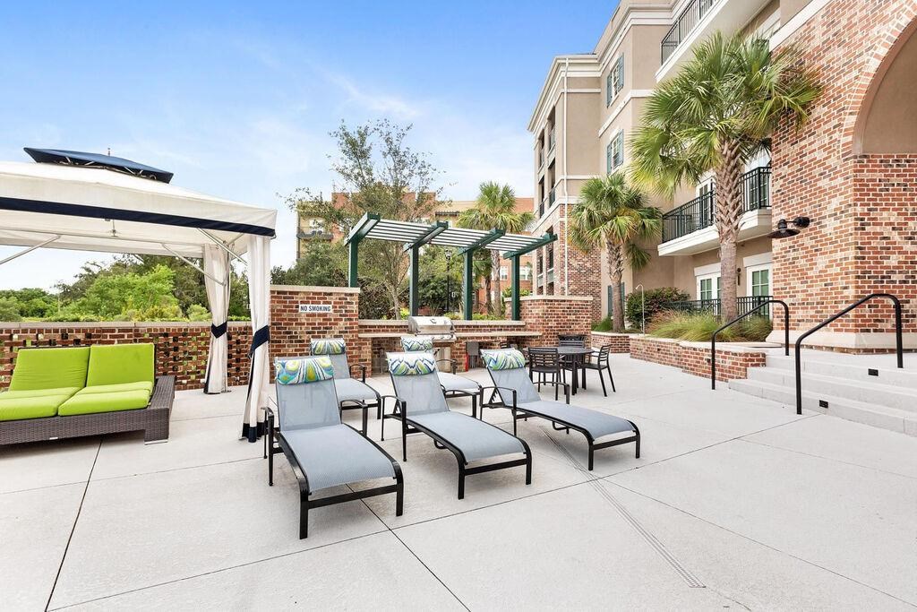 a large patio with chairs and tables outside of a building