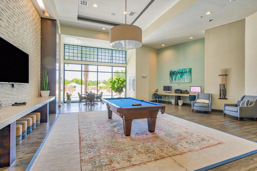 a game room with a pool table and a tv
