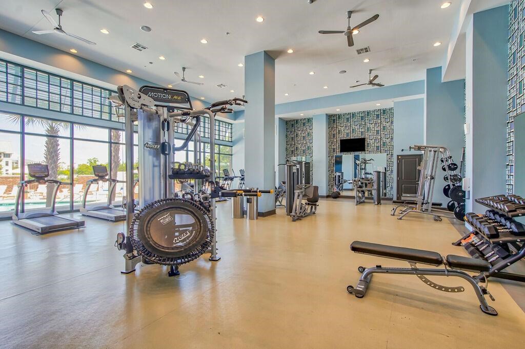 a workout room with weights and other exercise equipment and a large window