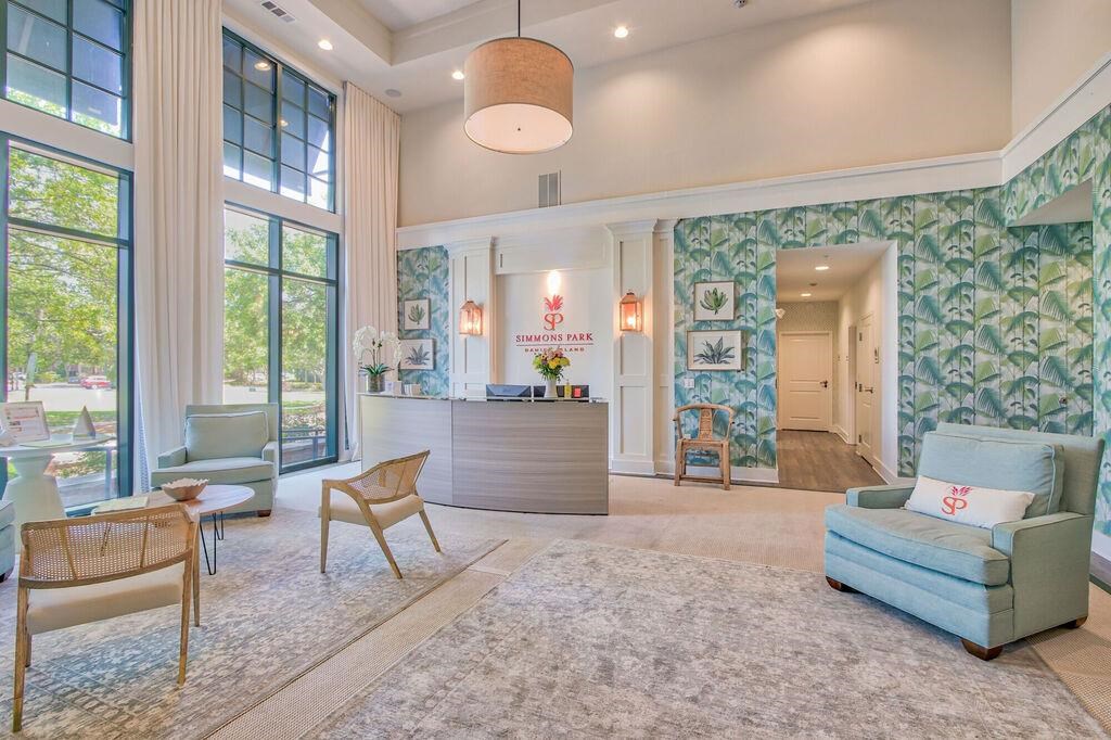 a lobby with a reception desk and chairs