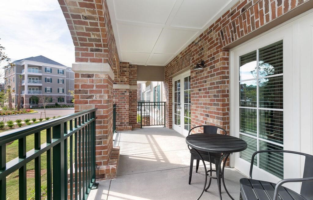 a patio with a table and chairs on a balcony