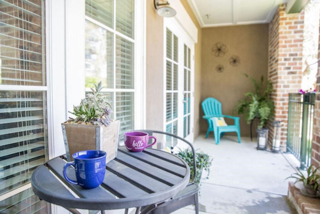 a porch with a table and coffee cups on it