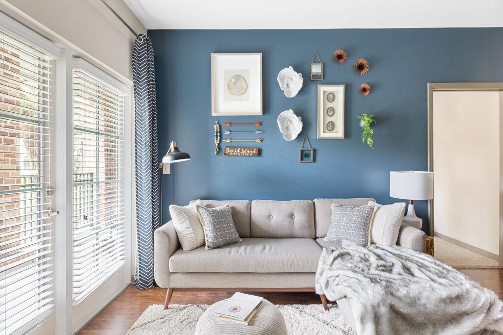 a living room with a couch and a blue wall